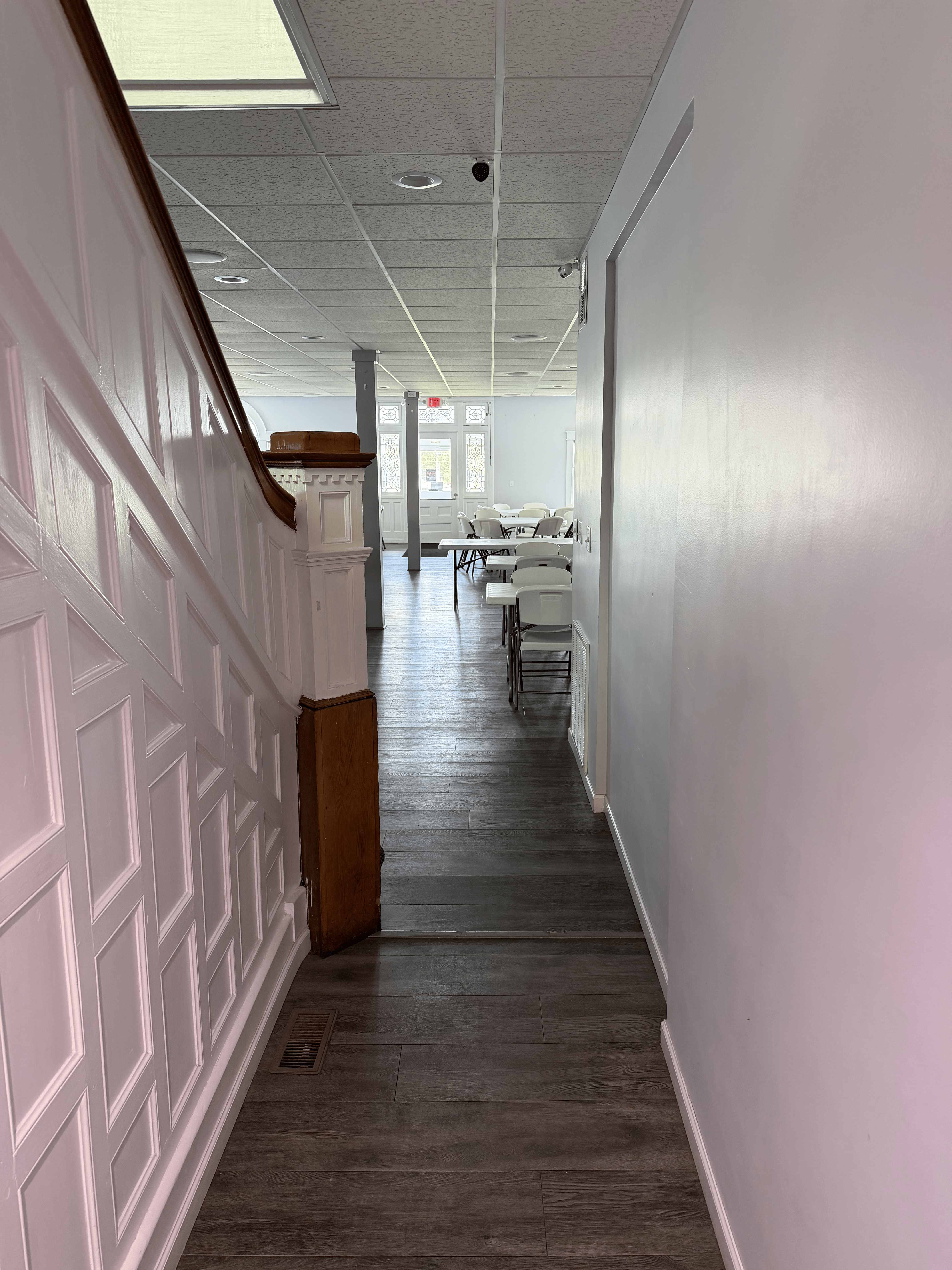 Wainscoted interior hallway leading into the main event hall