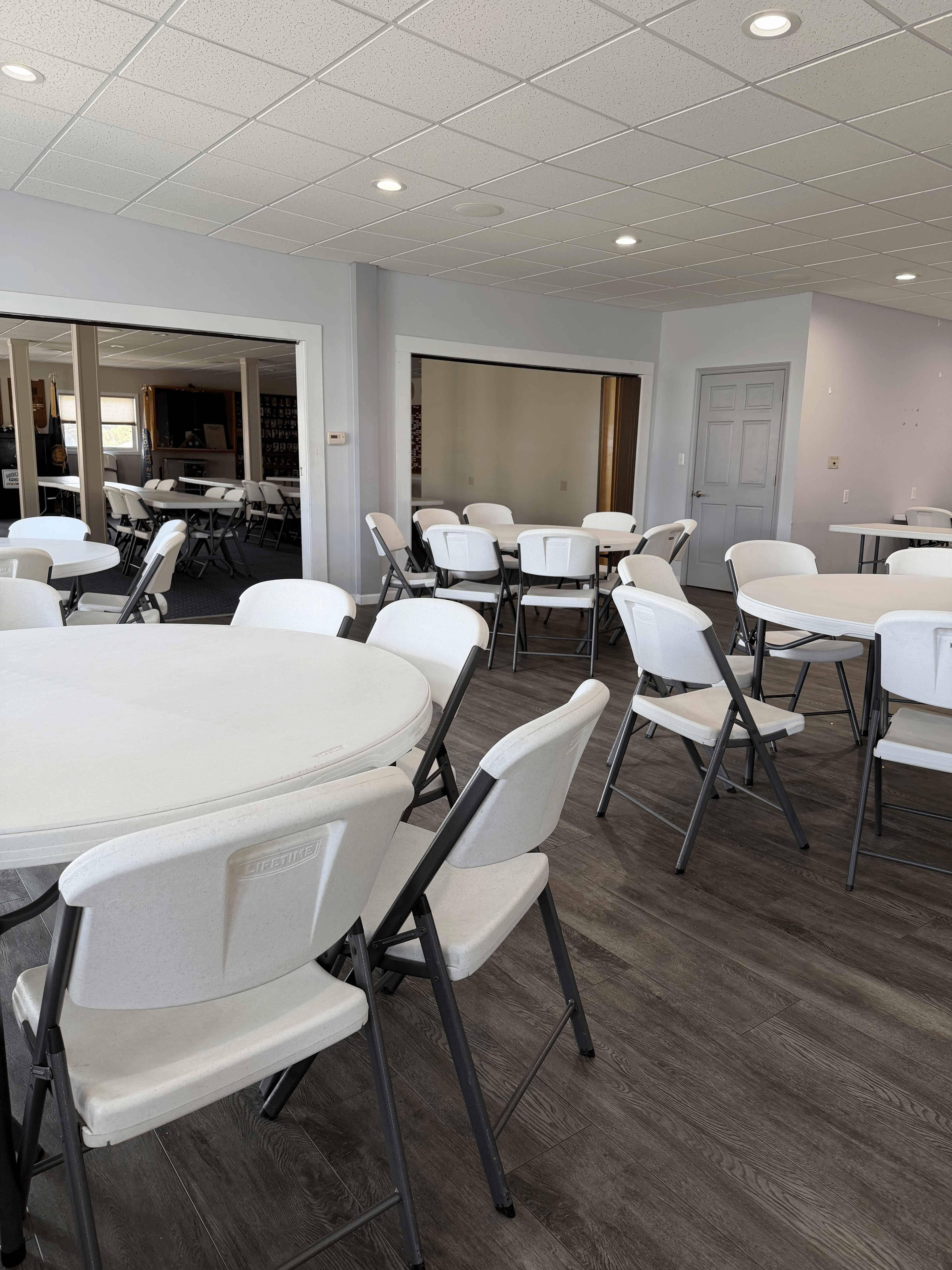 Seating area with round tables opening into adjoining meeting rooms